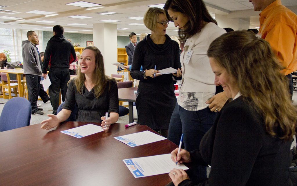 Teachers signing a health pledge