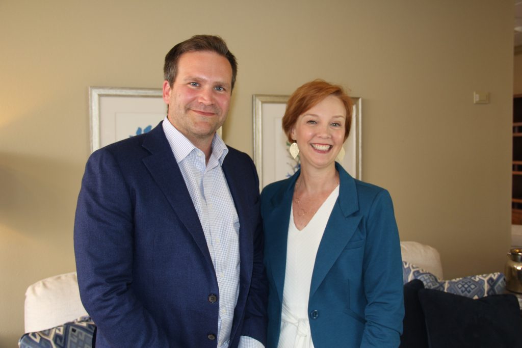 Amy McGeady, new CEO of It's Time Texas, stands next to Baker Harrell, the founder. Both are wearing blue blazers and smiling at the camera. 