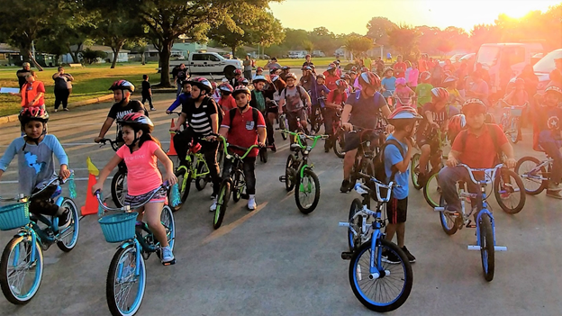 A group of kids riding bikes outside